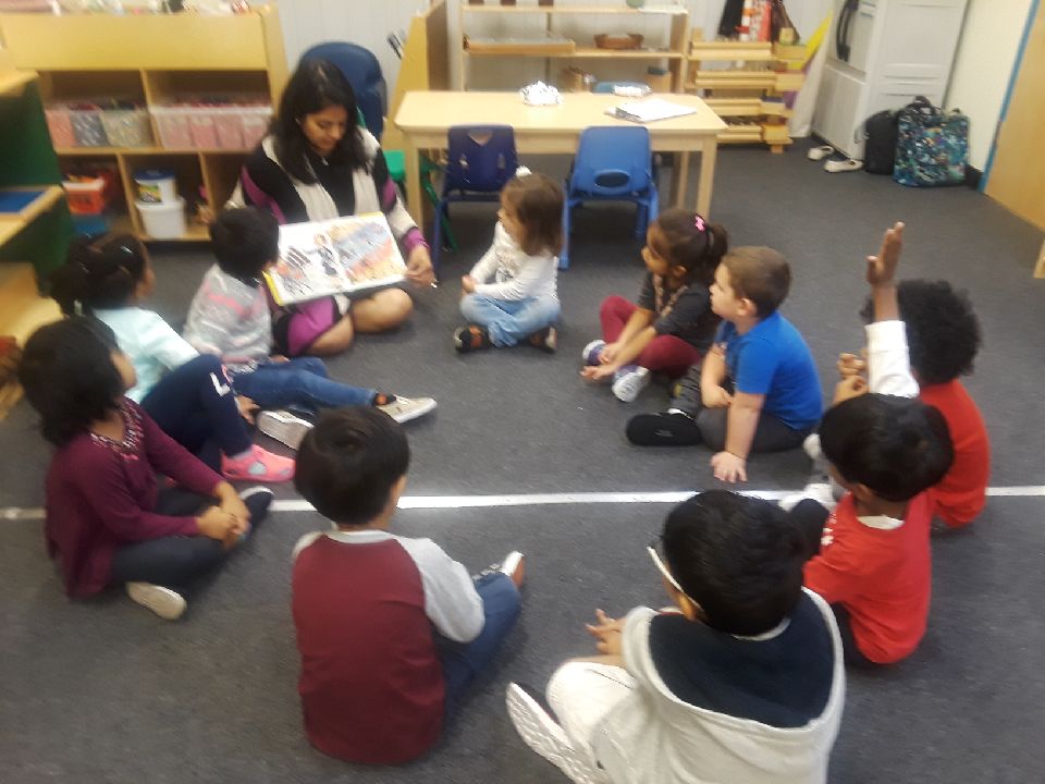 Children sitting in a circle listening to a story.